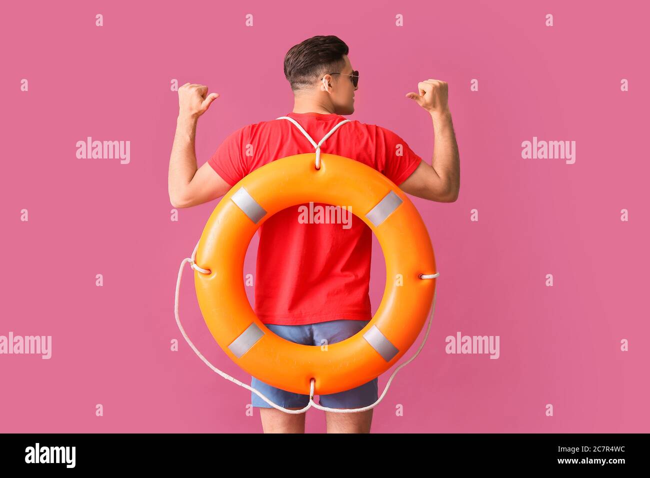 Beach rescuer with lifebuoy on color background Stock Photo - Alamy