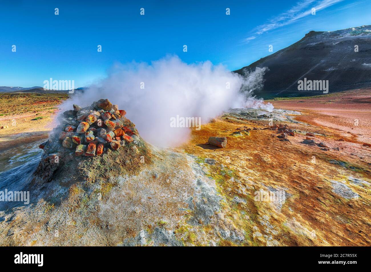 Steaming cone in Hverir geothermal area with boiling mudpools and steaming fumaroles in Iceland  Location: geothermal area Hverir, Myvatn region, Nort Stock Photo