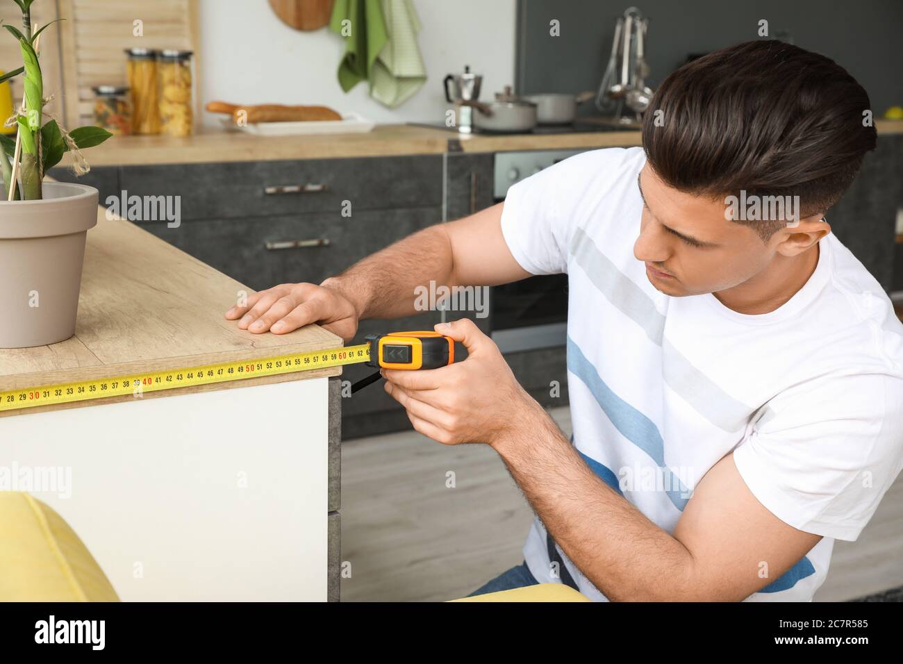 Handsome man using ruler in hi-res stock photography and images - Alamy