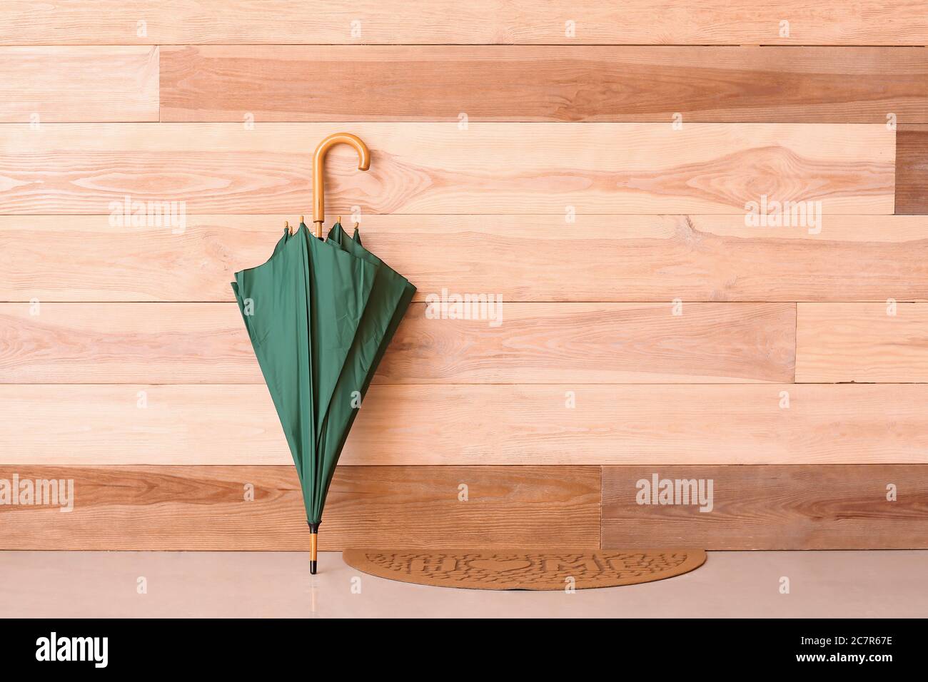 Stylish umbrella near wooden wall Stock Photo