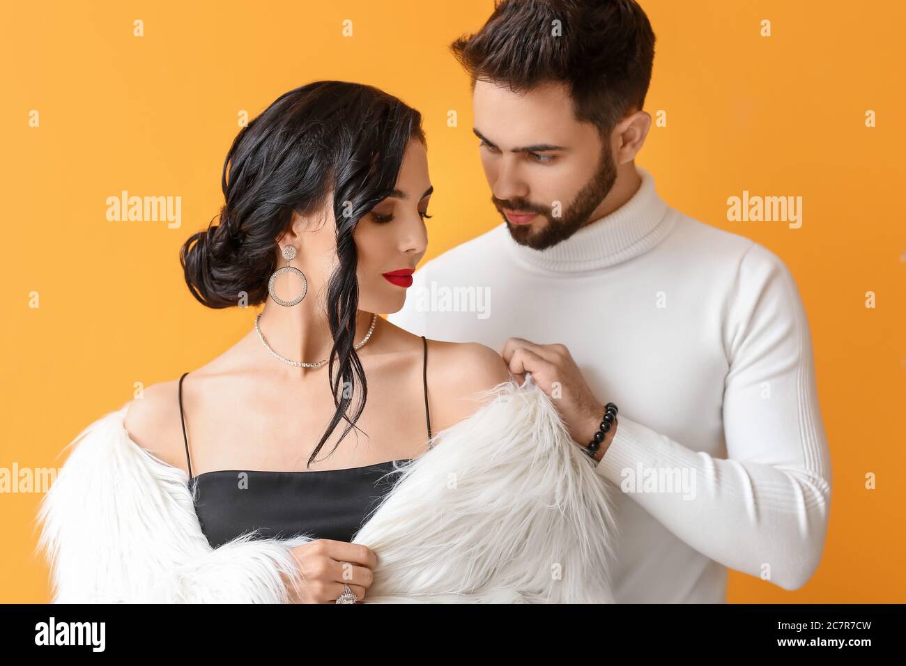 Young couple wearing stylish accessories on color background Stock Photo