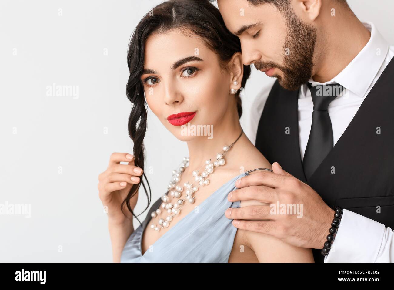 Young couple wearing stylish accessories on light background Stock Photo