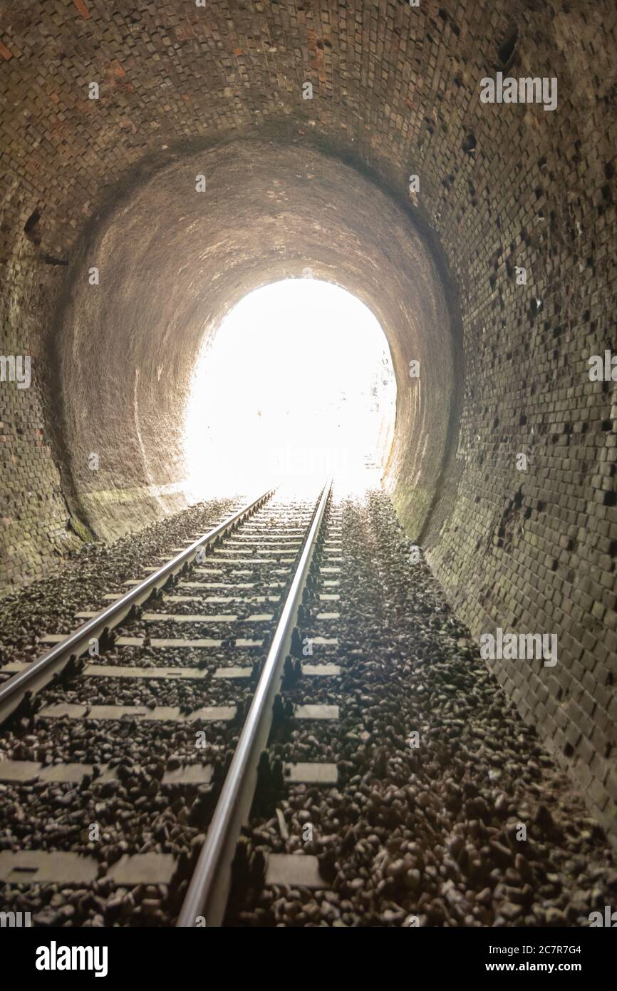 Light at the end of train tunnel Stock Photo