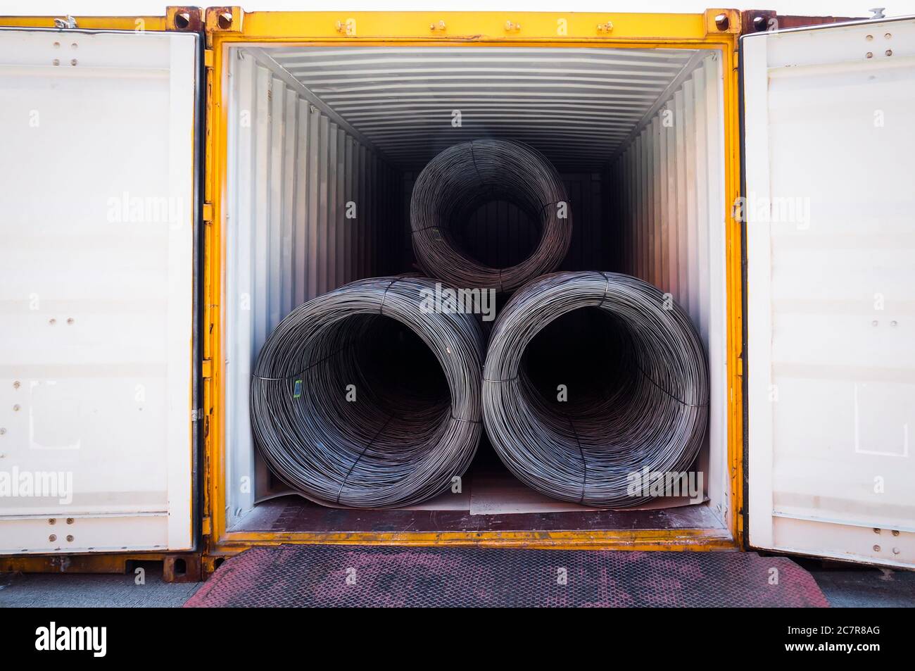 Coils of steel wire rod stuffed inside container. Container open for