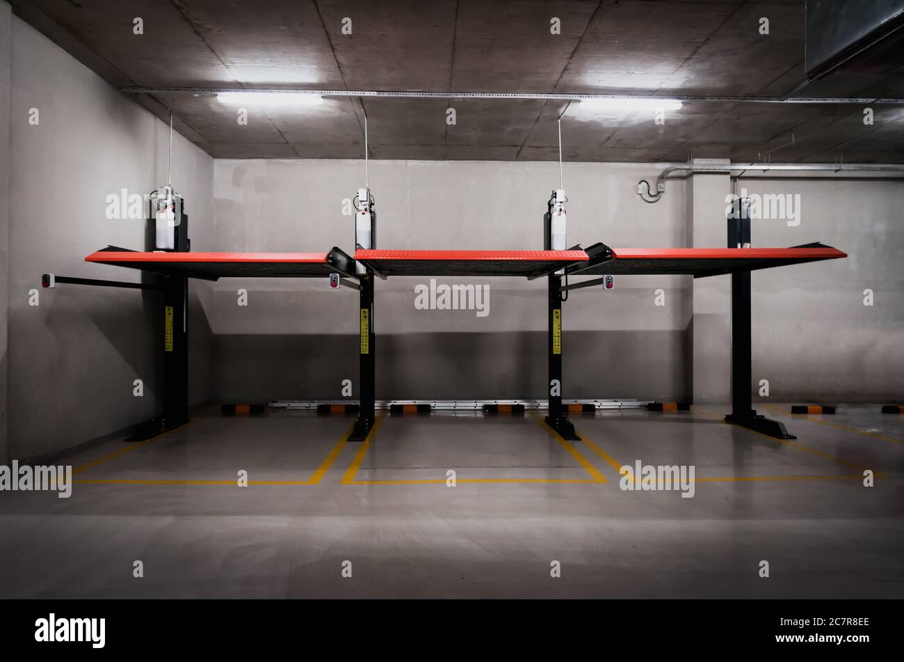 Elevated car parking equipment at office building basement. Car parking space. Stock Photo