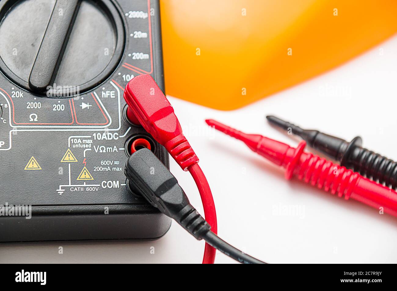 Closeup shot of a digital multimeter with black and red wires attached