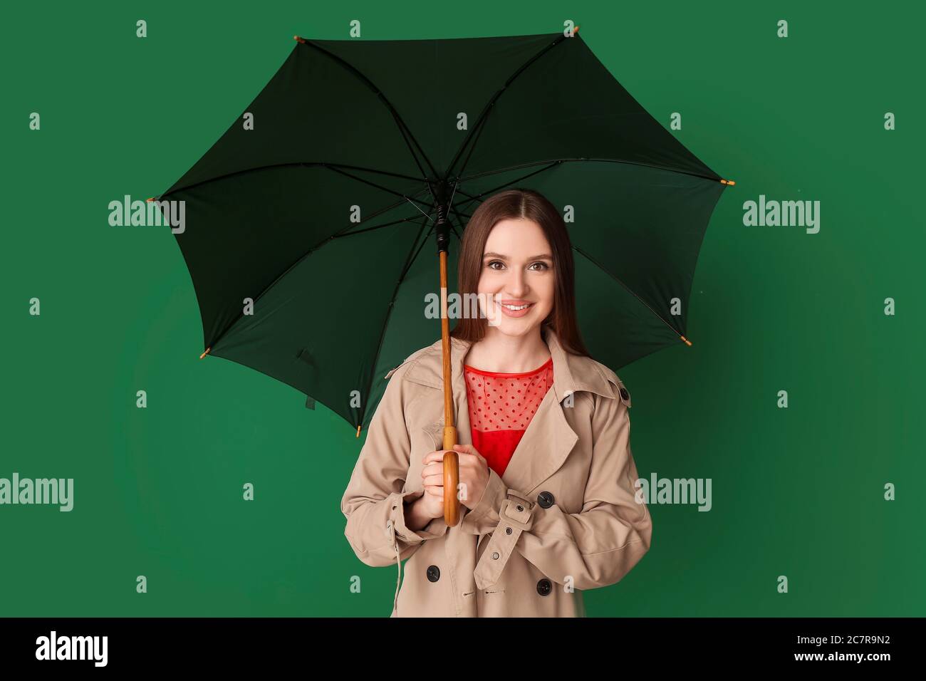 Beautiful woman with umbrella on color background Stock Photo - Alamy