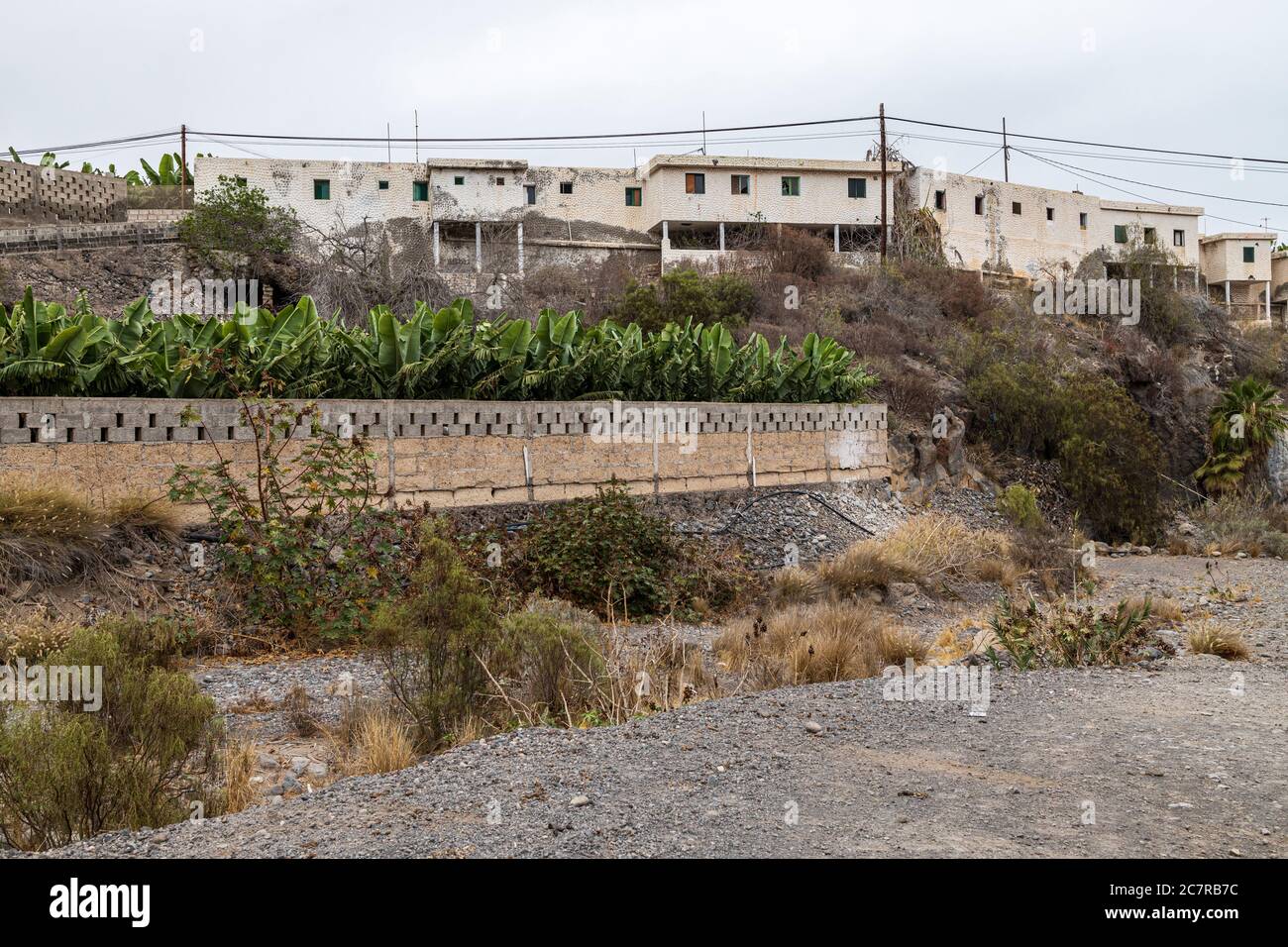 Terraced row of old derelict finca workers houses above a barranco in Playa San Juan, Tenerife, Canary Islands, Spain Stock Photo