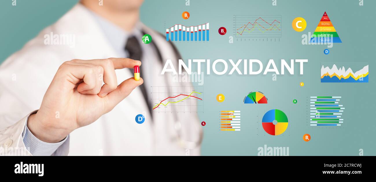 Nutritionist giving you a pill with ANTIOXIDANT inscription, healthy lifestyle concept Stock Photo