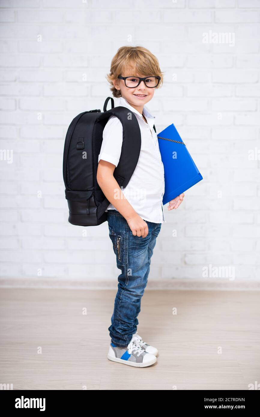 education concept - full length portrait of cute little school boy in ...