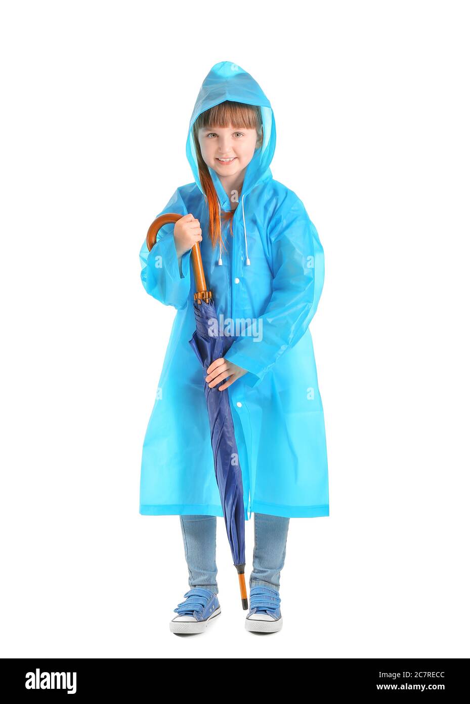 Cute little girl in raincoat and with umbrella on white background