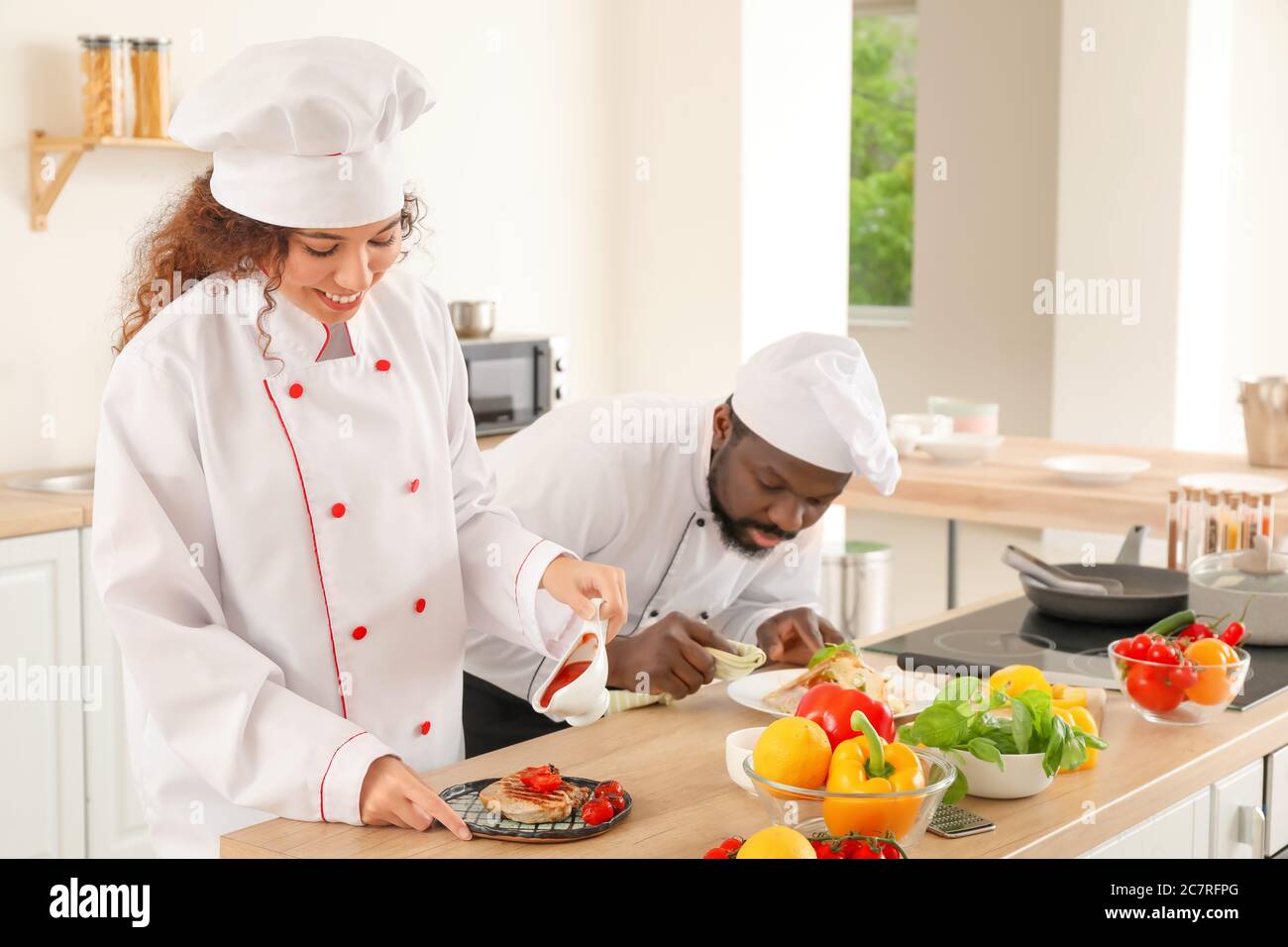 African-American chefs cooking in kitchen Stock Photo