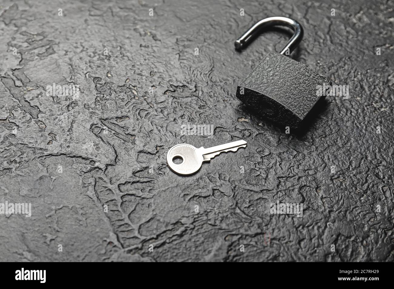 Key with lock on dark background Stock Photo - Alamy