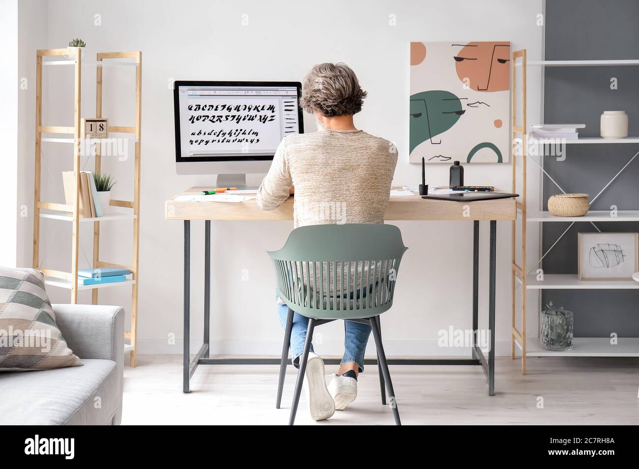 Senior male calligraphist working in office Stock Photo