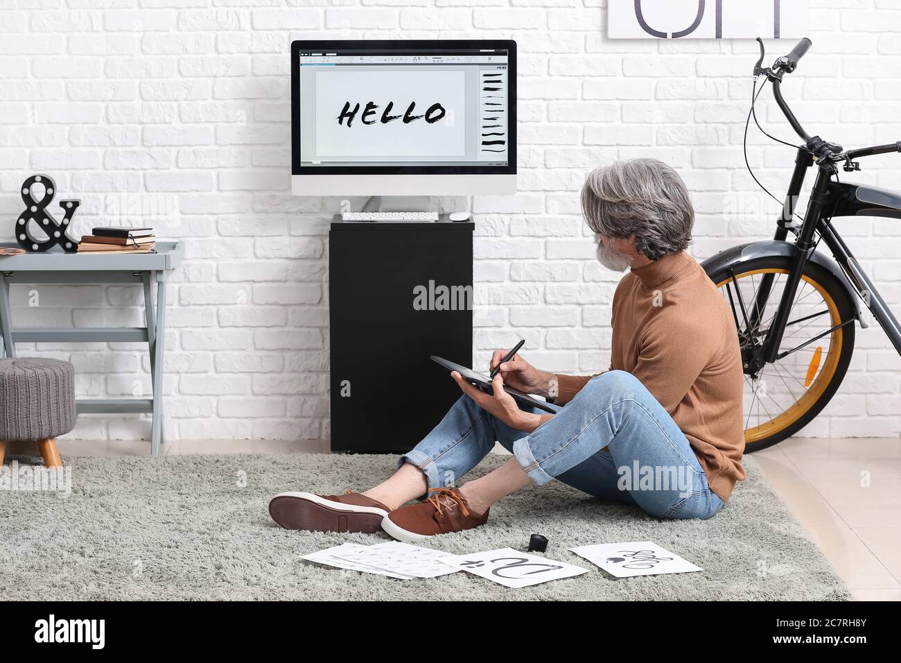 Senior male calligraphist working in office Stock Photo