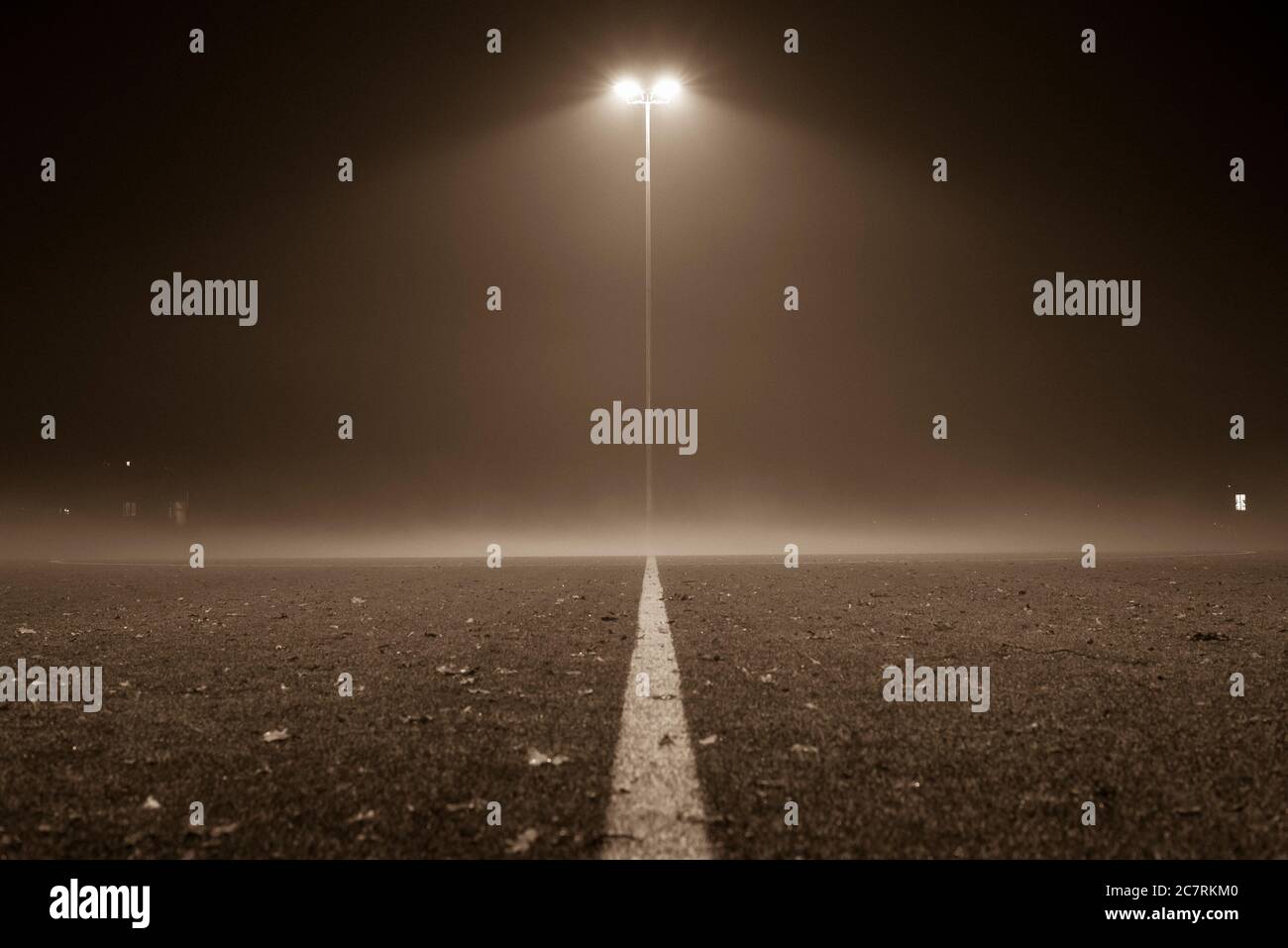 Foggy Footballfield, Soccer, football field at night with fog, lantern and fog, black and white photo Stock Photo