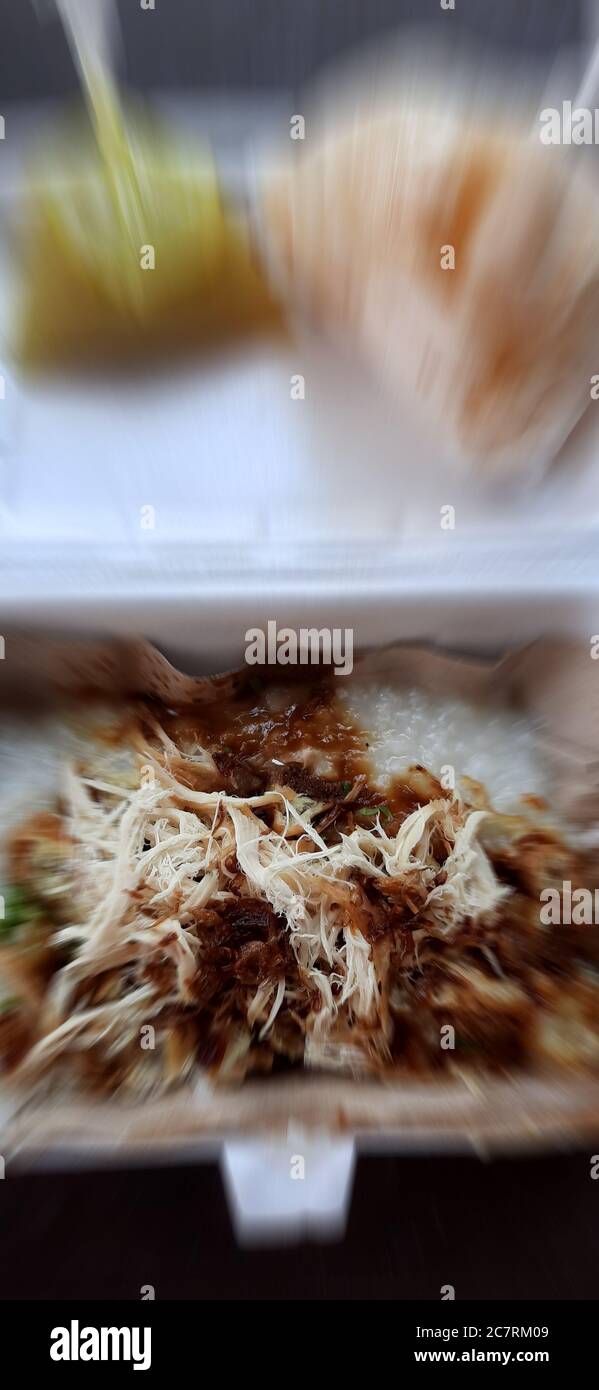 Vertical shot of traditional Indonesian dish Bubur Ayam porridge with chicken Stock Photo