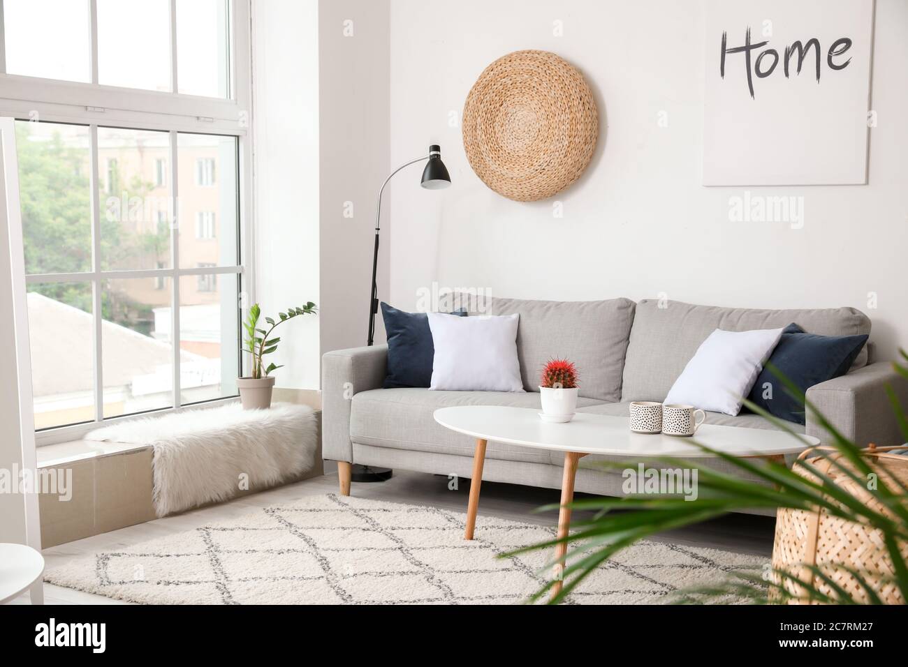 Stylish interior of living room with comfortable sofa Stock Photo - Alamy