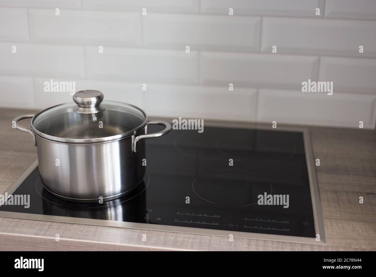 metal pot on electric stove in modern kitchen Stock Photo Alamy