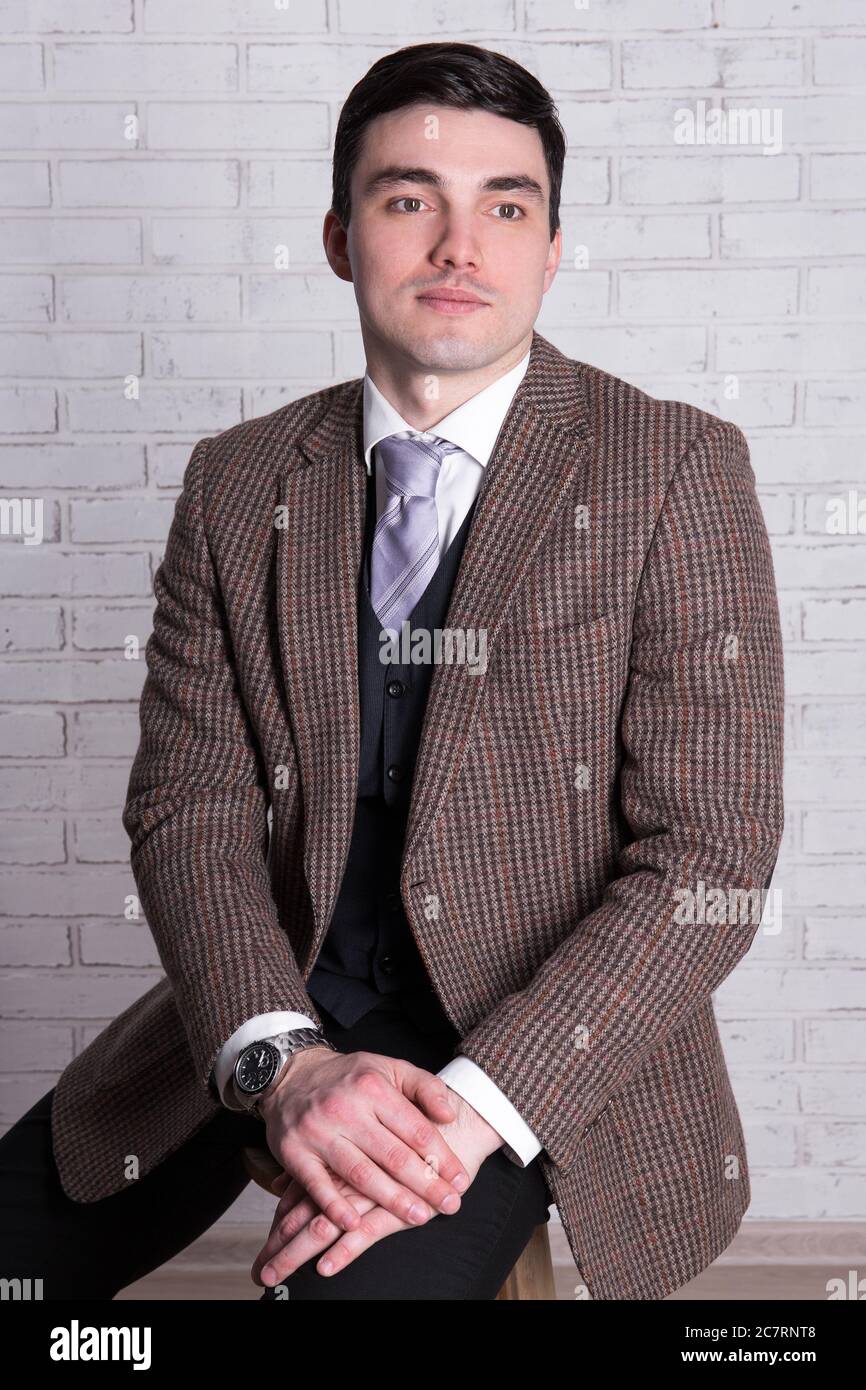 portrait of dreaming young handsome man over white brick wall Stock ...