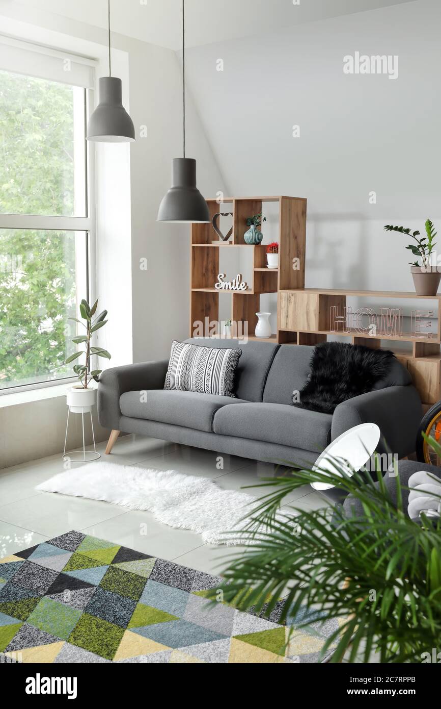 Stylish interior of living room with comfortable sofa Stock Photo - Alamy