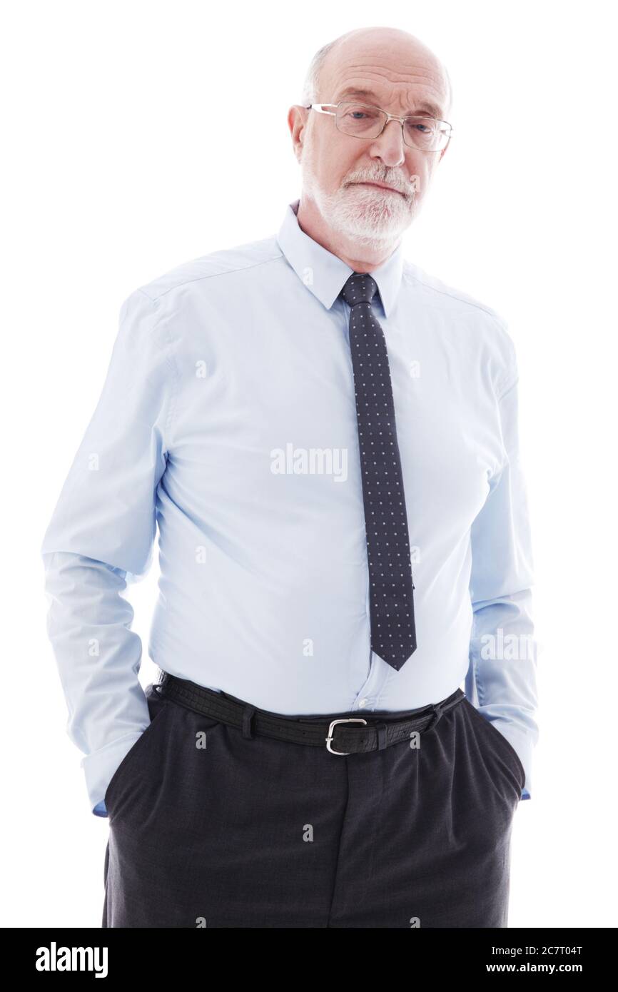 Senior Businessman stands with hands in pockets studio isolated on white background Stock Photo