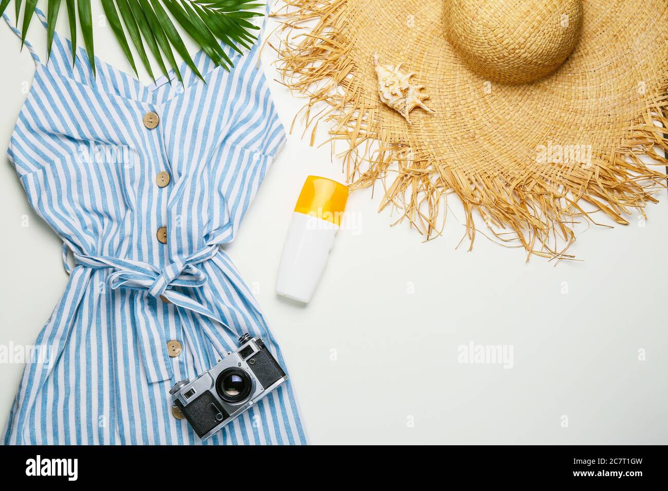Summer composition with female clothes on light background Stock Photo