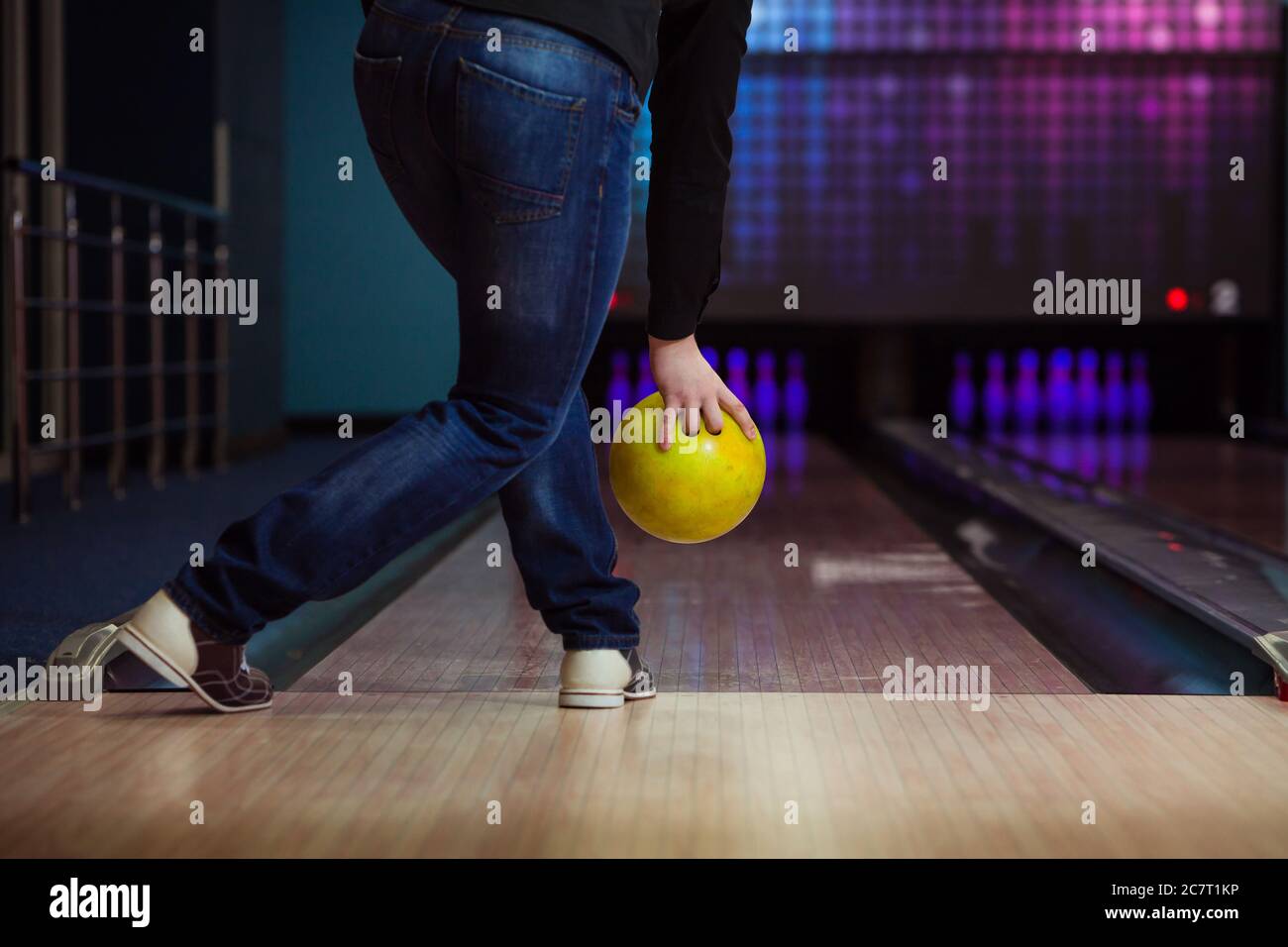 Male legs and bowling ball in alley. Stock Photo