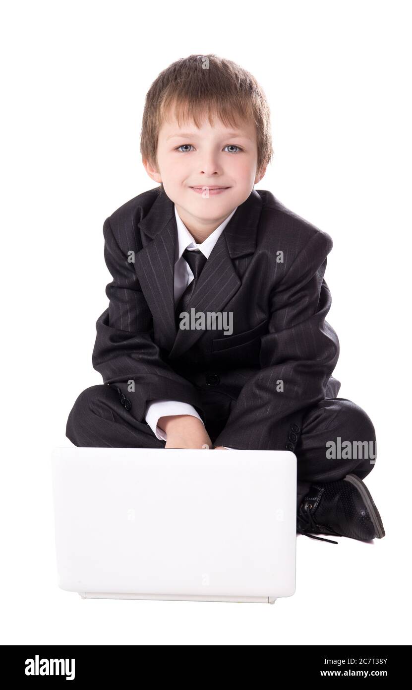 cute little boy in business suit with laptop isolated on white