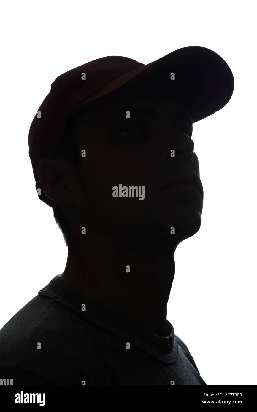 Portrait of a young man in cap, side view - silhouette Stock Photo