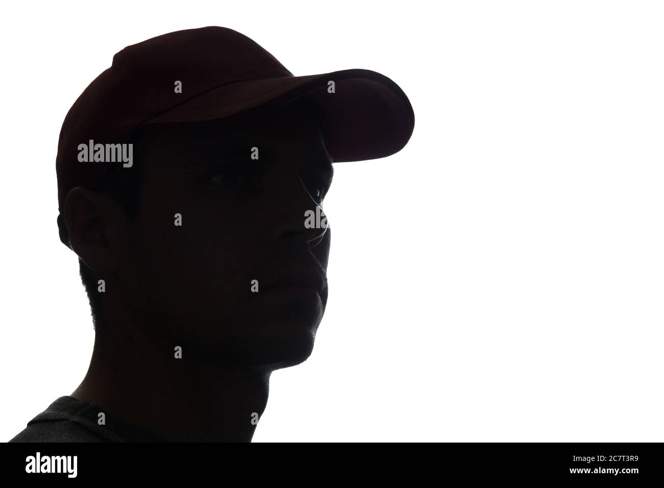 Portrait of a young man in cap, side view - silhouette Stock Photo