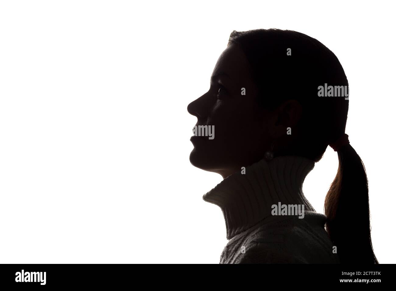 Young woman looking up - horizontal silhouette of a side view Stock Photo