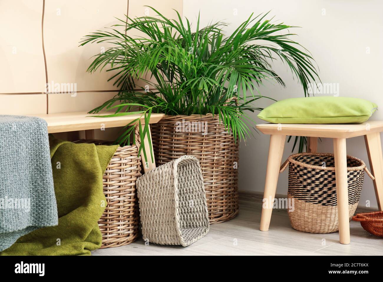 Bench with wicker baskets and houseplant in room Stock Photo Alamy