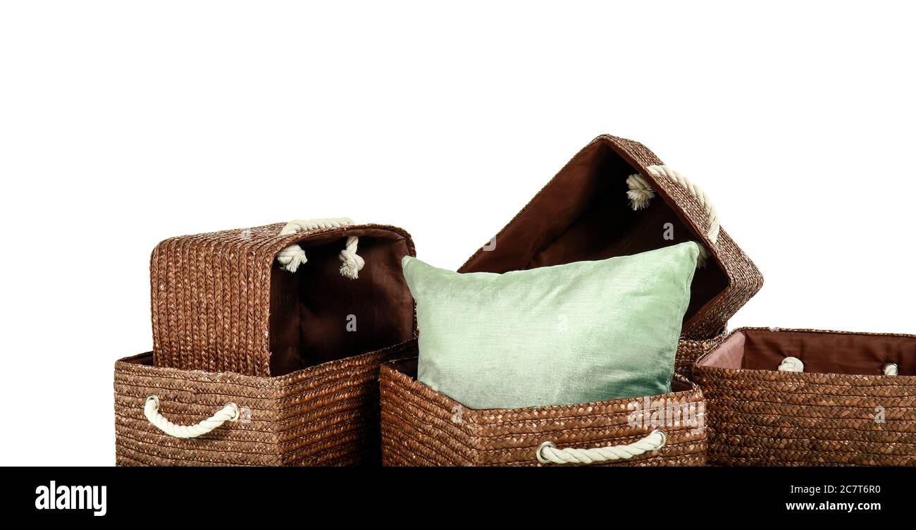 Wicker baskets with pillow on white background Stock Photo Alamy