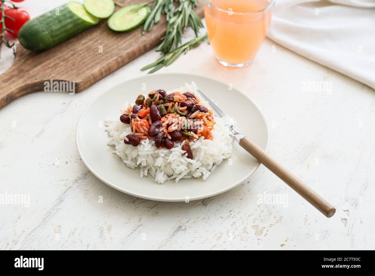 Plate with tasty rice, beans and vegetables on white background Stock ...