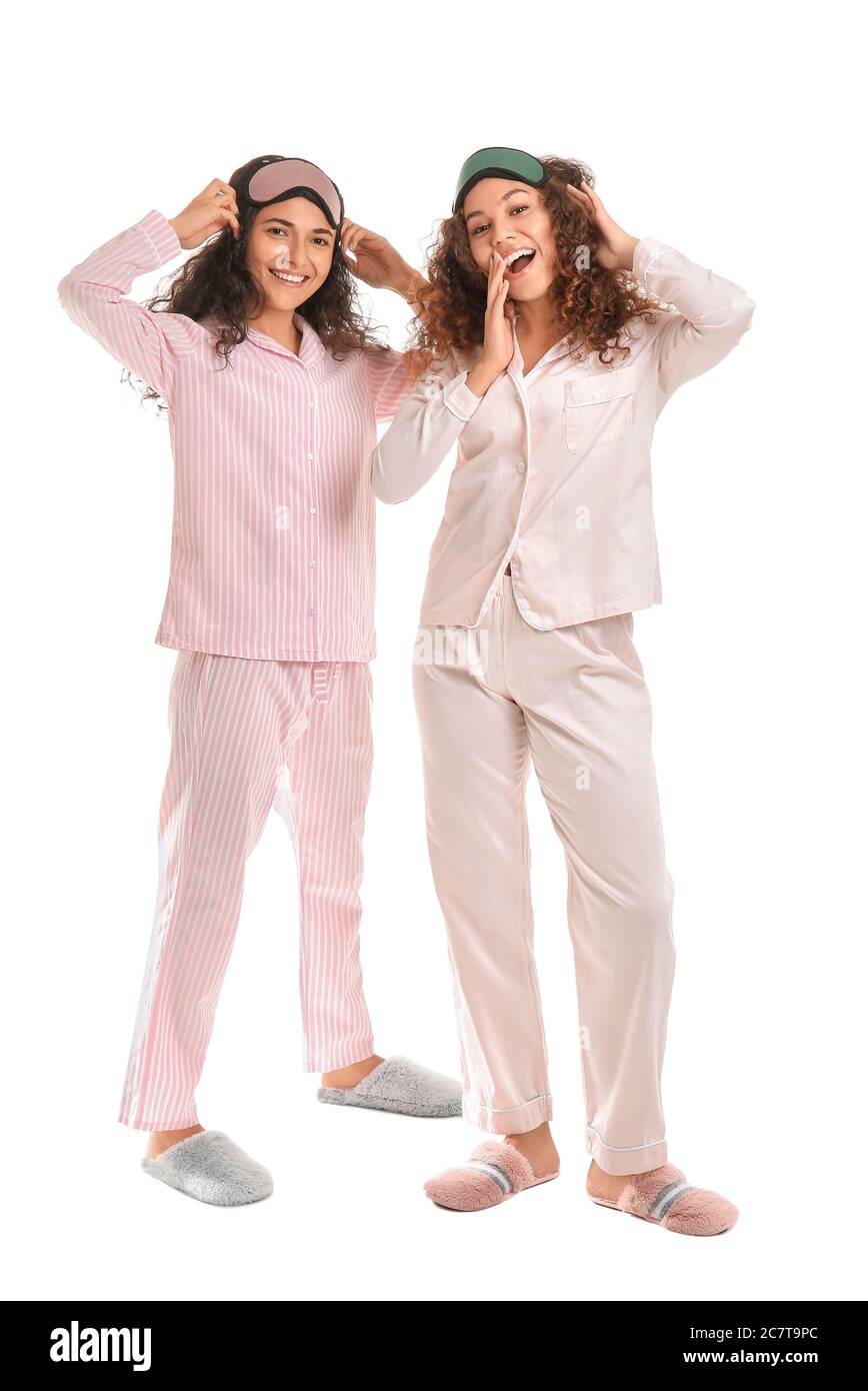 Beautiful young women in pajamas and with sleep masks on white background Stock Photo Alamy