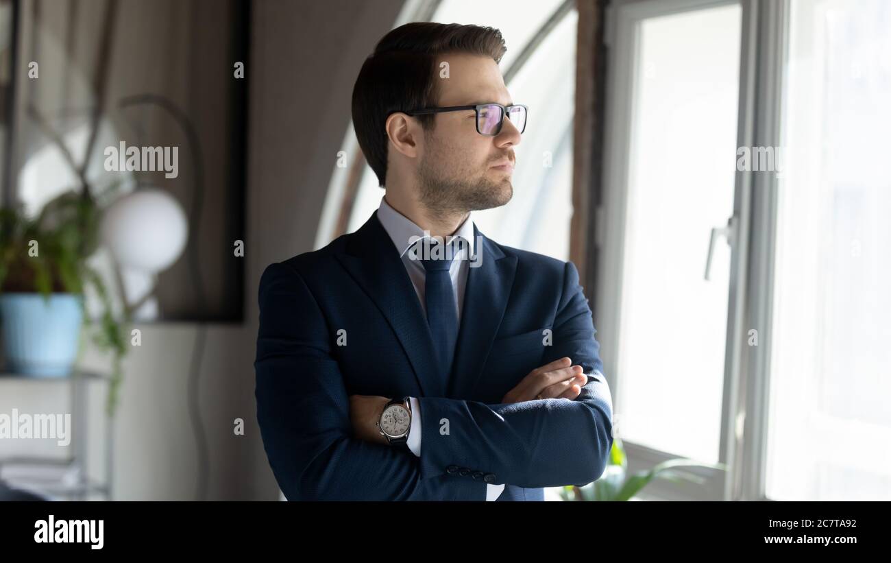 Pensive Caucasian businessman look in distance thinking Stock Photo Alamy