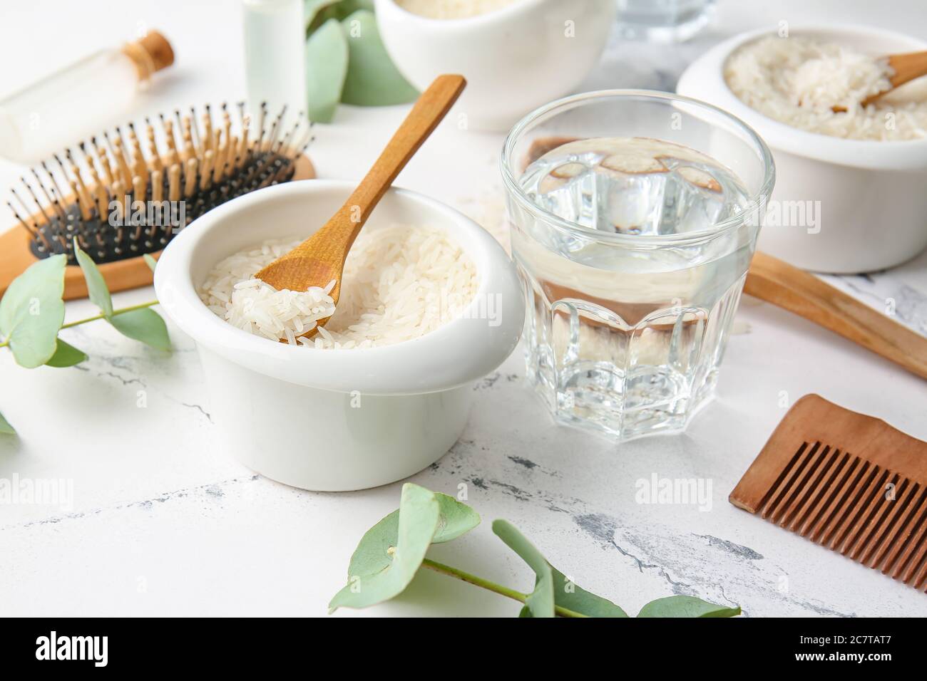 Glass of water with rice in bowl on white background Stock Photo - Alamy
