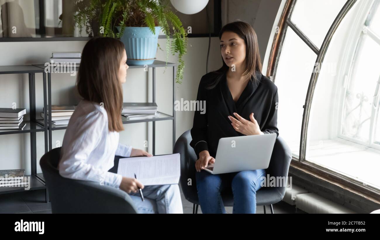 Multiracial female colleagues on briefing hi-res stock photography and ...
