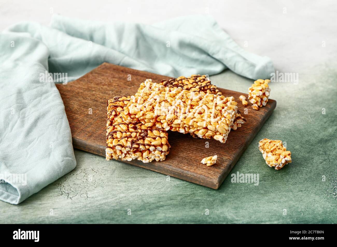 Board with crispy rice bars on color background Stock Photo - Alamy