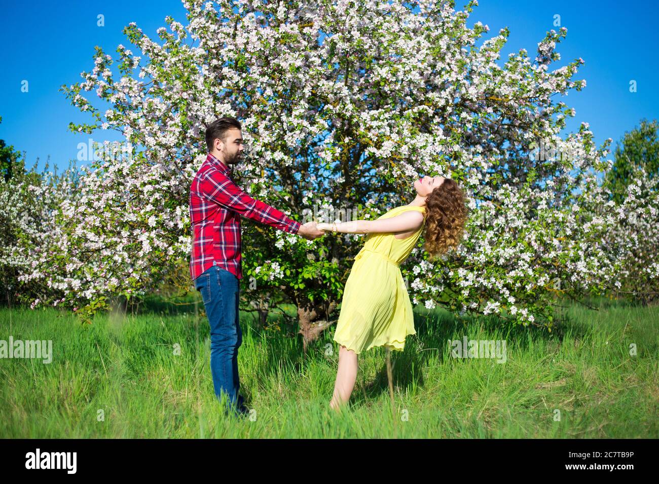 Couple kissing at blooming tree hi-res stock photography and images - Alamy