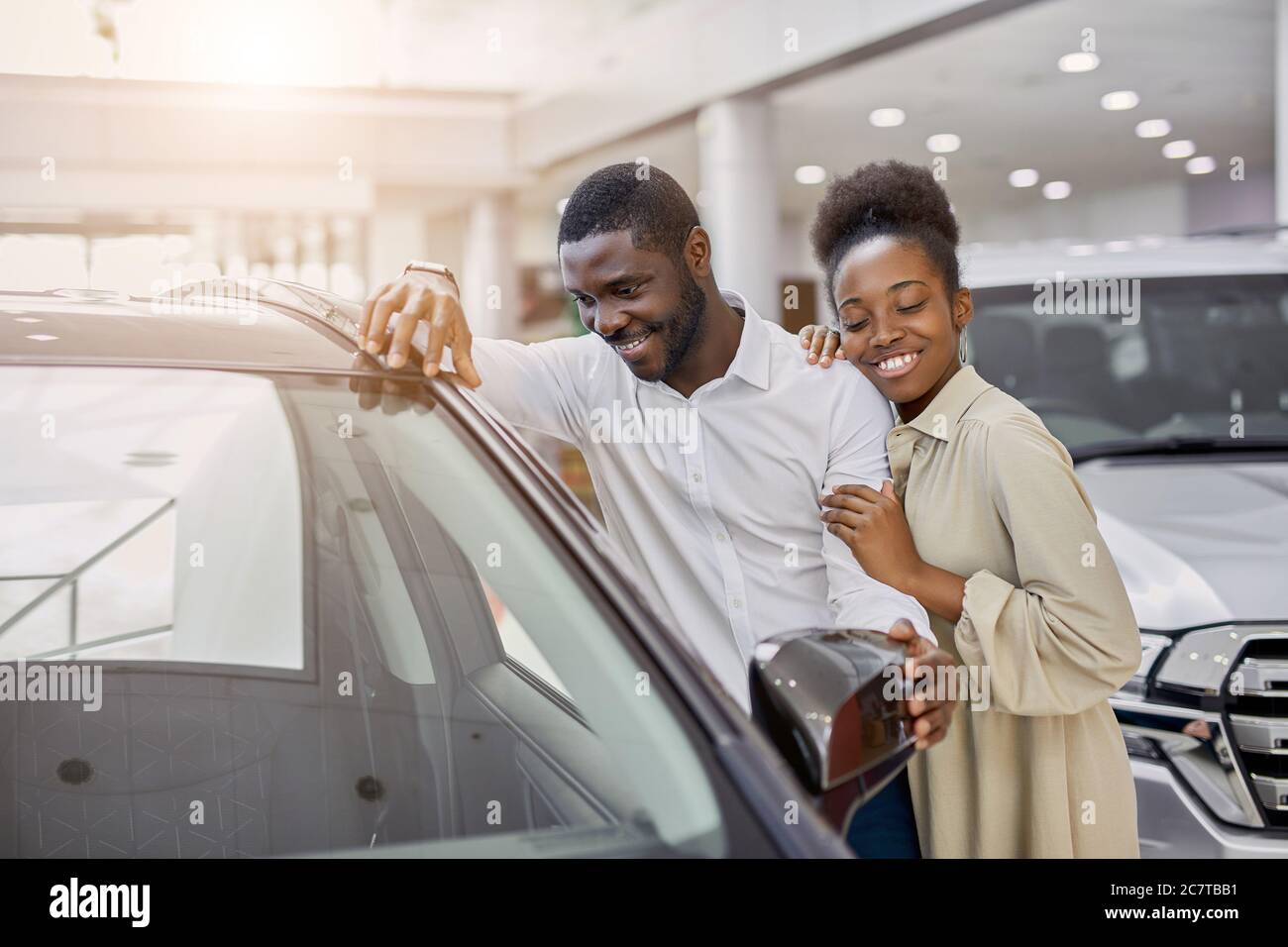 portrait of beautiful african married couple came in dealership to buy