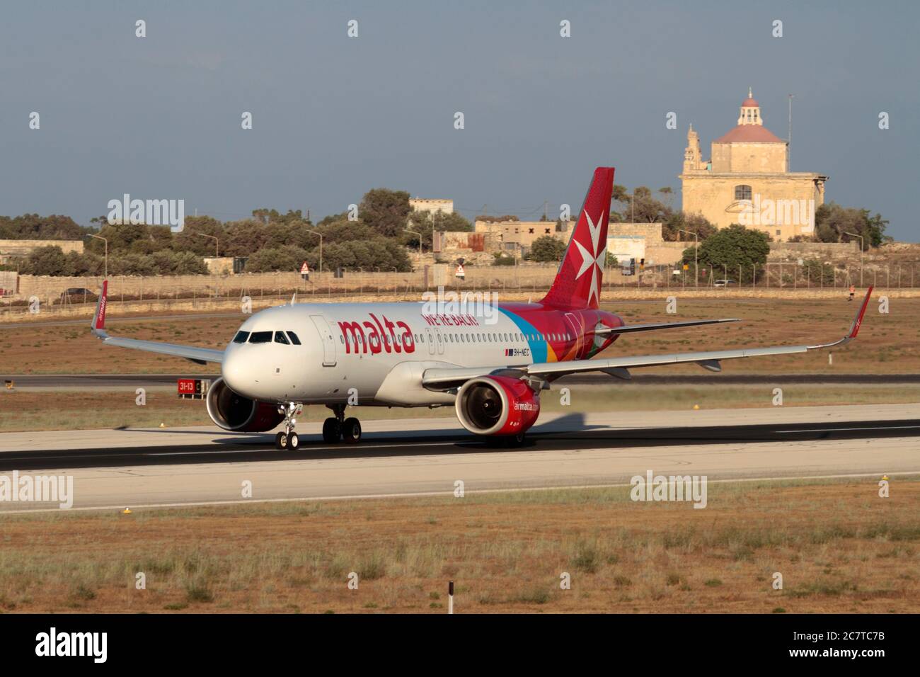 Air Malta Airbus A320neo airliner with 'We're Back!' legend taking off from Malta, symbolising recovery of commercial air travel after COVID-19. Stock Photo