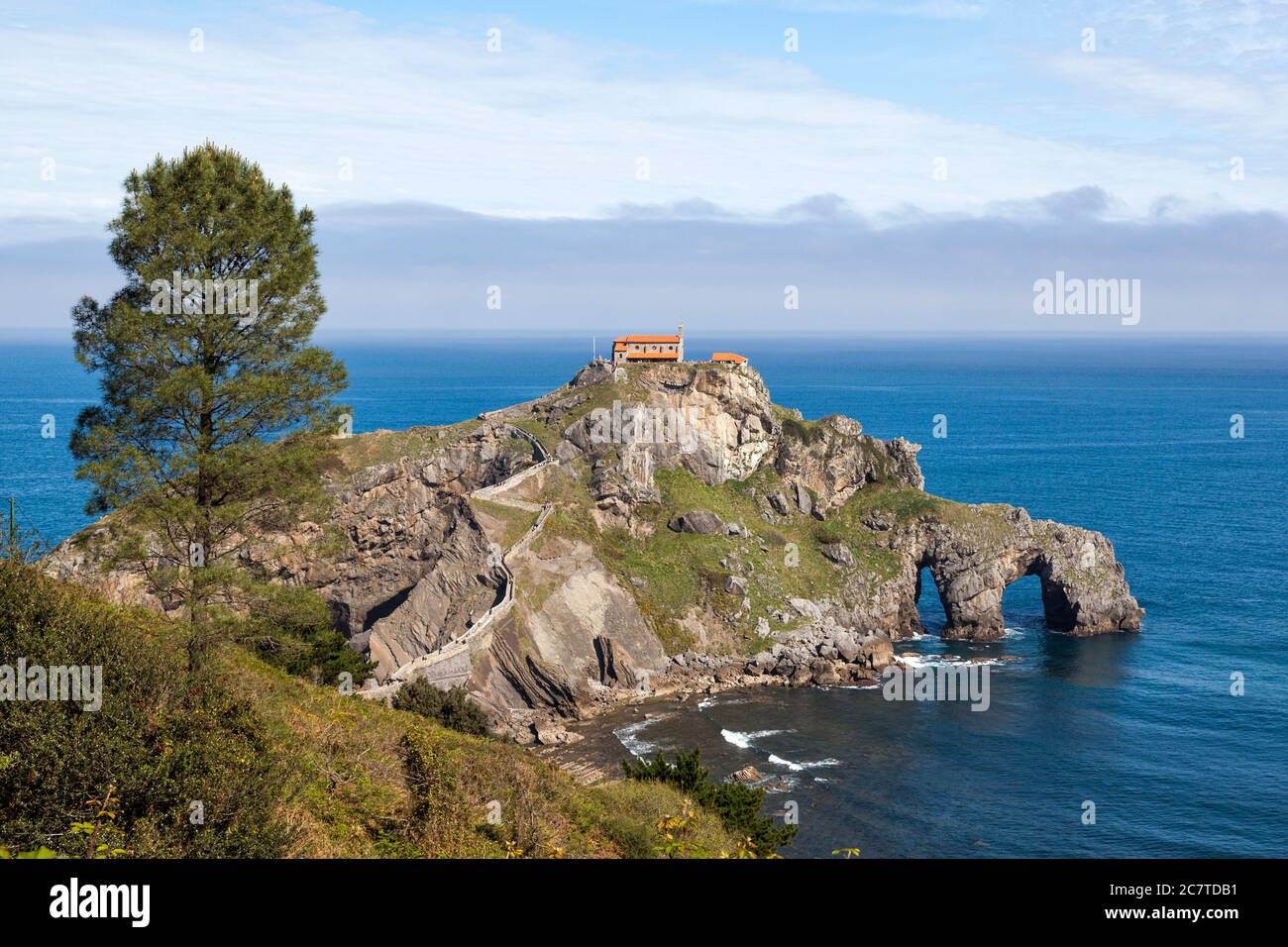 San Juan de Gaztelugatxe, Basque Country, Spain. It is an islet on the coast of Biscay, connected to the mainland by a man-made bridge. On top of the Stock Photo