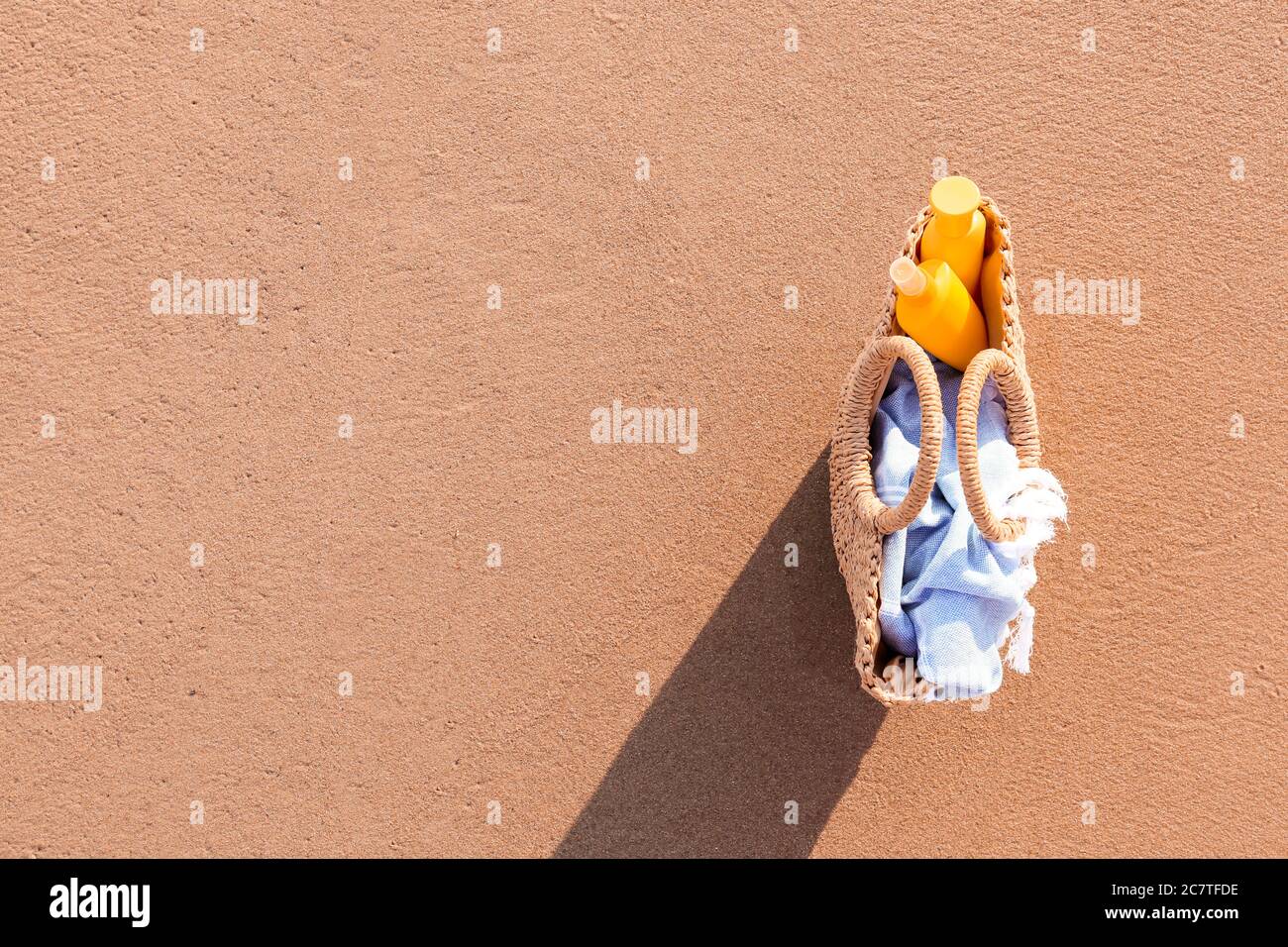 Bag with sunscreen cream on beach Stock Photo