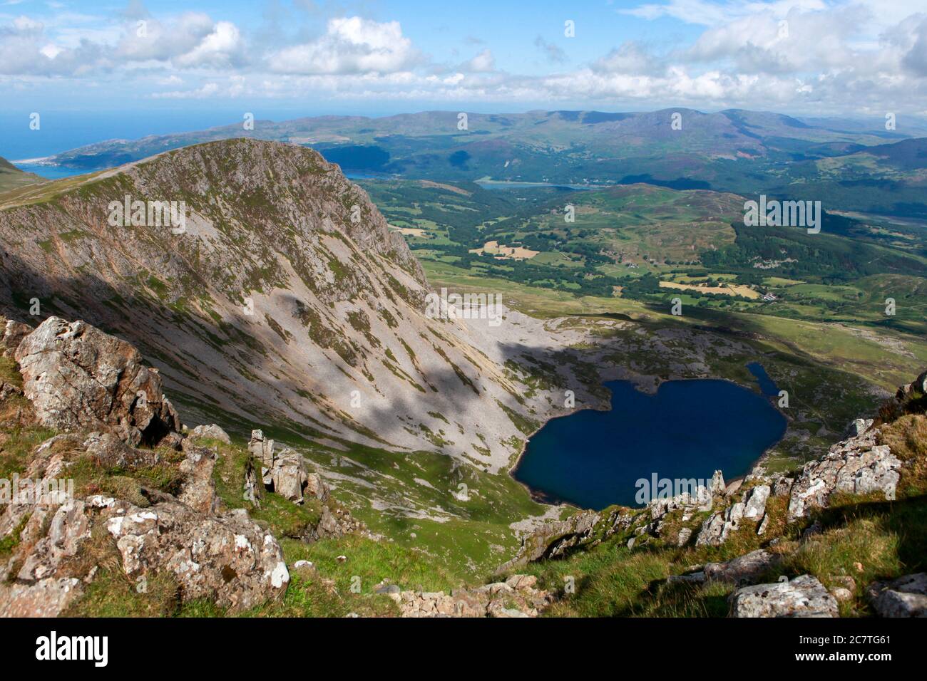 Summer view of Llyn y Gadair, Cyyfrwy and the hills and countryside around Dolgellau from Penygadair, the summit of Cadair Idris Stock Photo