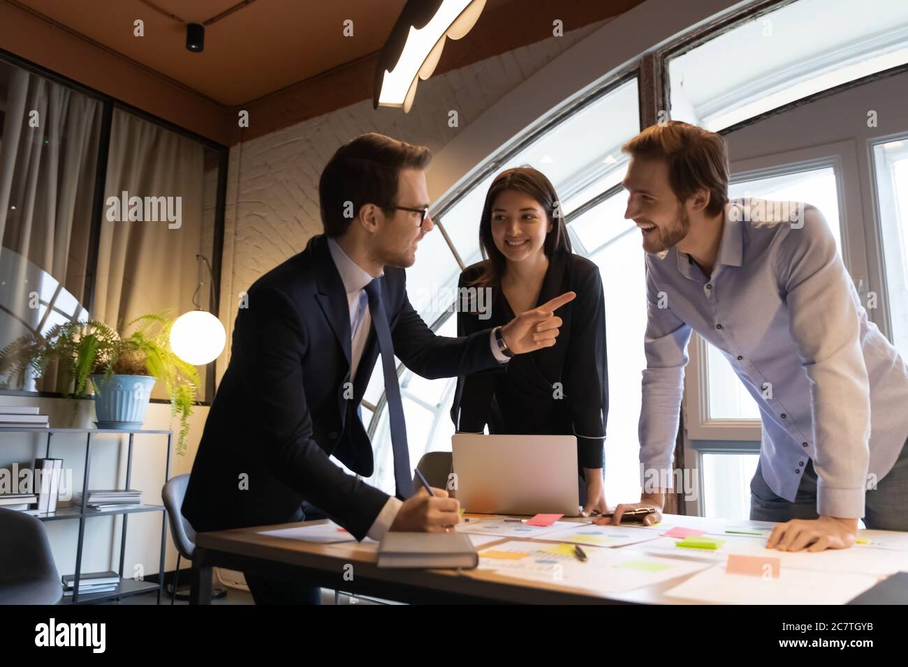 Excited diverse colleagues have fun brainstorming at meeting Stock ...