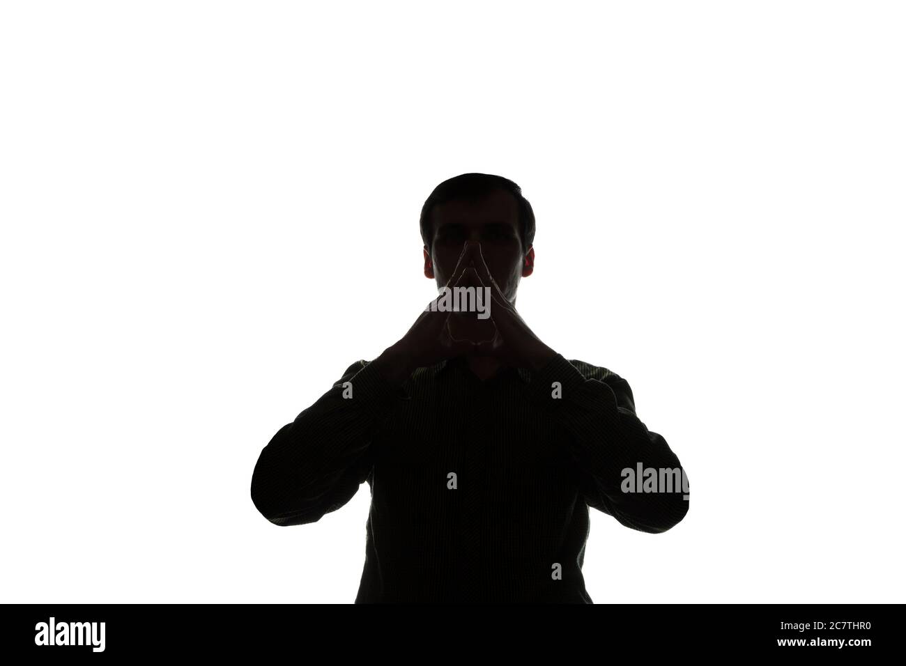 Portrait of a young man, think, hands near the face, side view - silhouette Stock Photo