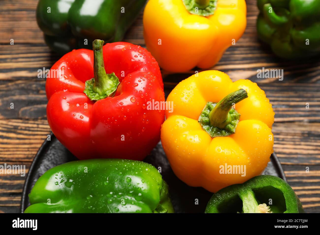 Fresh bell peppers on wooden background Stock Photo - Alamy