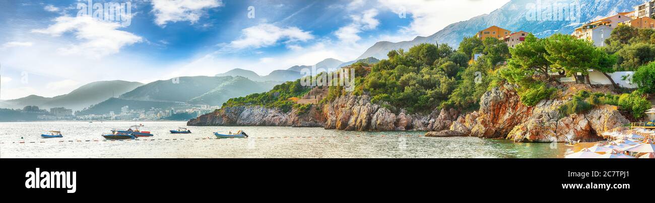 Picturesque summer view of Adriatic sea coast in Budva Riviera near Przno village with lots of boats in the sea. Location: Przno village, Montenegro, Stock Photo